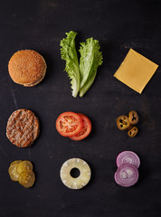 hamburger items over dark backgrournd