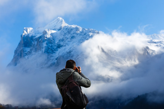 Male photographer taking pictures in Mountains