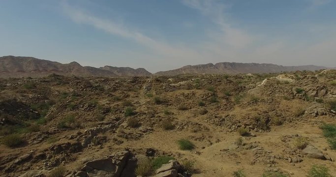 Flying Backwards Over Rocky Desert Landscape