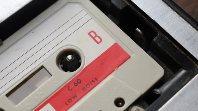  Slow motion audio tape player supply spindle footage - Old music archives on cassette in casettophone close-up