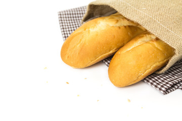 French  baguettes in sack on white background