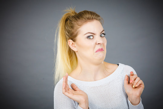 Disgusted woman having funny face expression