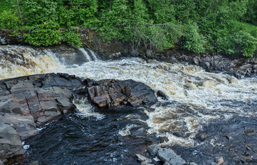 Naklejka na ściany i meble Picturesque landscape with a waterfall in the forest of Karelia