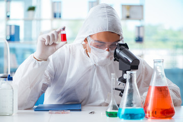 Chemist working in the laboratory with hazardous chemicals