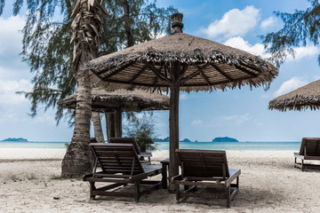 Lounge chairs and sunshade umbrella on the beach