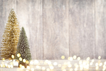 Artificial Christmas tree on a wooden background.