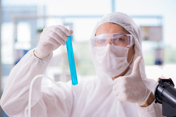 Chemist working in the laboratory with hazardous chemicals