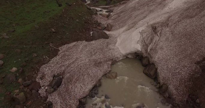 Creek Passes Under Large Rock