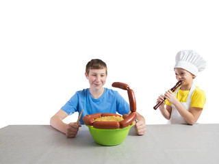 Little girl in the form of a chef with an apron and a cap smiles and plays a pipe, and next to it...