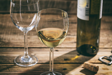 White wine glass on wooden background