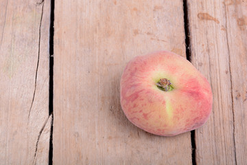Nectarine fruit on old wooden plate background close up