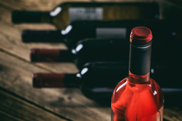 Rose wine bottle on wooden background