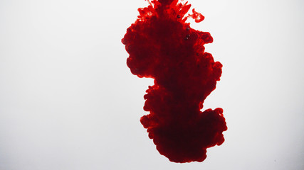 Dark red ink cloud over white background