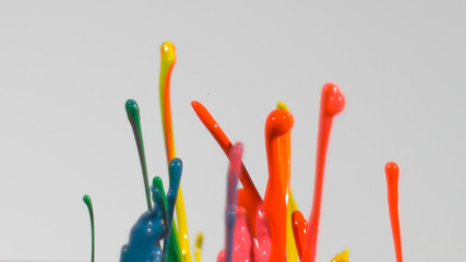 Rainbow paint splatter in front of white background