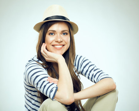 Portrait of smiling sitting woman wearing hat