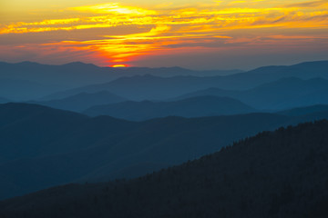 Fototapeta na wymiar Spectacular Sunset in Smoky Mountains with Blue Ridge hills layered to the horizon with orange red sky