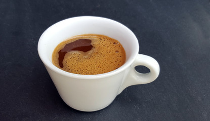 White coffee cup on dark background