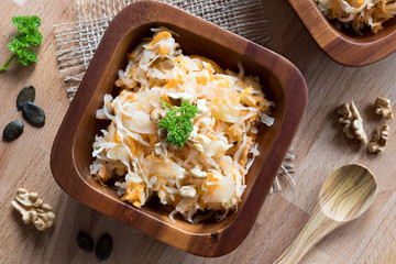 Fermented cabbage and carrots in a wooden bowl