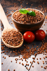 Bowl of buckwheat kasha on wooden table