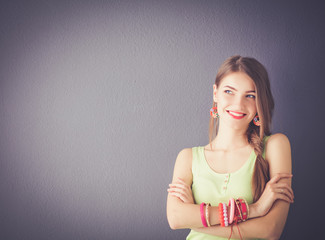 Attractive young woman standing on grey background