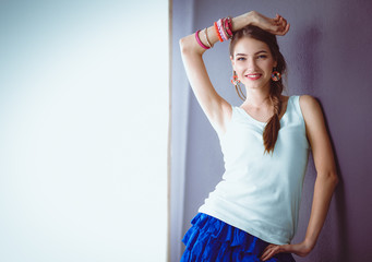 Attractive young woman standing on grey background