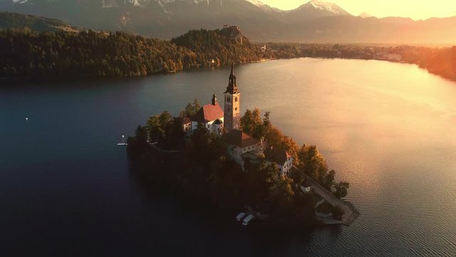 Aerial view of Lake Bled and Bled island showing old buildings including pilgrimage church