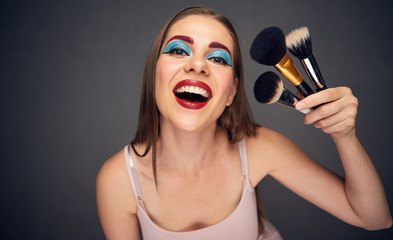 Make up artist holding brush.