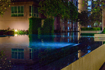 Courtyard of an apartment house with shallow blue pool
