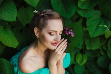 portrait of beautiful smiling young blond women.closed eyes.green ivy nature background