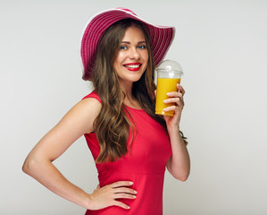 Woman in red dress holding orange juice glass.