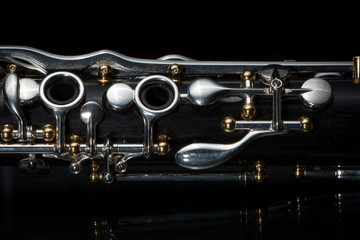 Details of a clarinet with silver keys and golden sockets