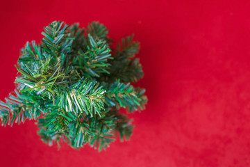 Red background with a Christmas tree.