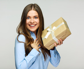 Smiling business woman holding paper gift box.