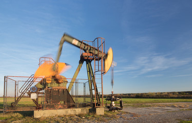 Fototapeta na wymiar Operating oil pump, blurred moving parts