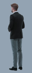 Businessman from the back - looking at something over a white ba