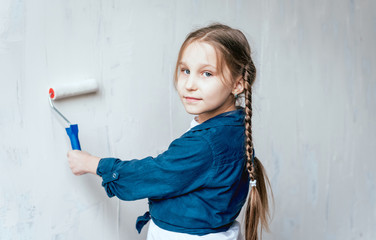 Little girl in a room with a wooden wall. Construction