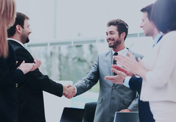 Business colleagues sitting at a table during a meeting with two