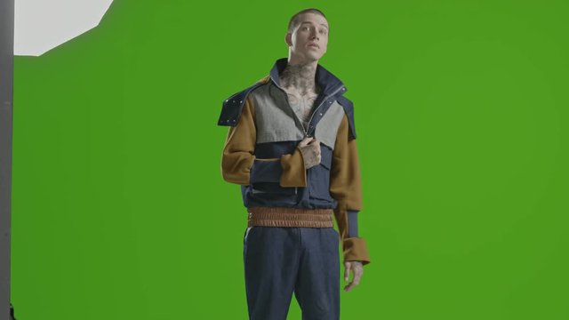 Handsome stylish fashion model - neck tattoo - male fashion model greenscreen - Fashion shot