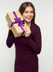 Happy woman holding gift box.