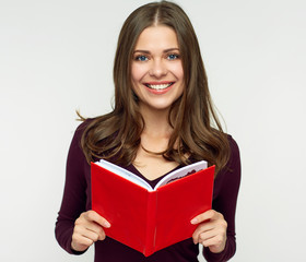 Smiling woman student holding red book.