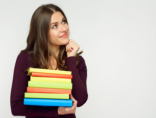 Close up portrait of student girl with books pile.