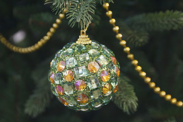 Glittering ball on a fir tree close-up. Christmas decorations