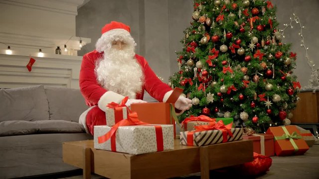 Happy Santa Claus packing box with Christmas present and banding ribbon