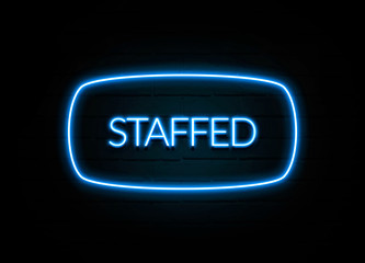 Staffed  - colorful Neon Sign on brickwall
