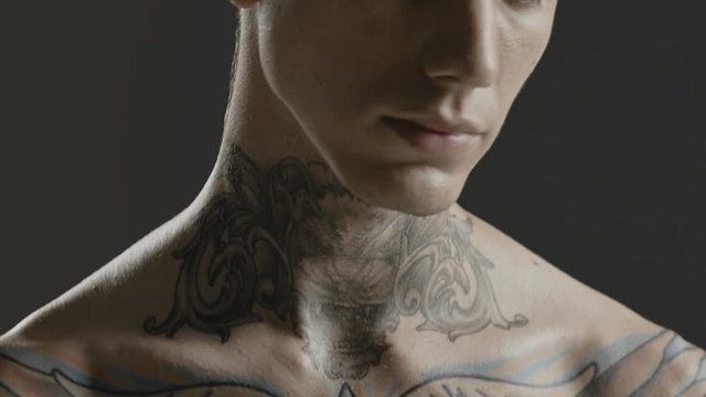 Handsome sexy young man stylish with tattoo on his neck, torso and hand - ultra close up body and face detail - greenscreen Prores - cinematic lighting