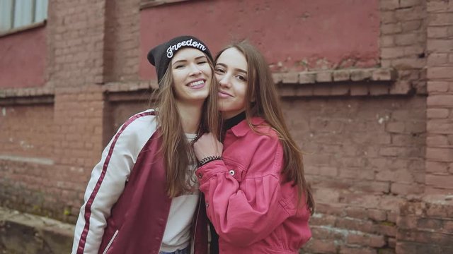 Two young hipster girl friends together having fun. Outdoors, lifestyle.