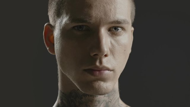 Handsome sexy young man stylish with tattoo on his neck, torso and hand - ultra close up body and face detail - greenscreen Prores - cinematic lighting