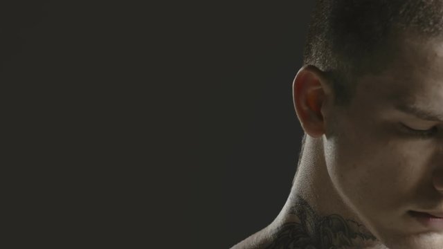 Handsome sexy young man stylish with tattoo on his neck, torso and hand - ultra close up body and face detail - greenscreen Prores - cinematic lighting