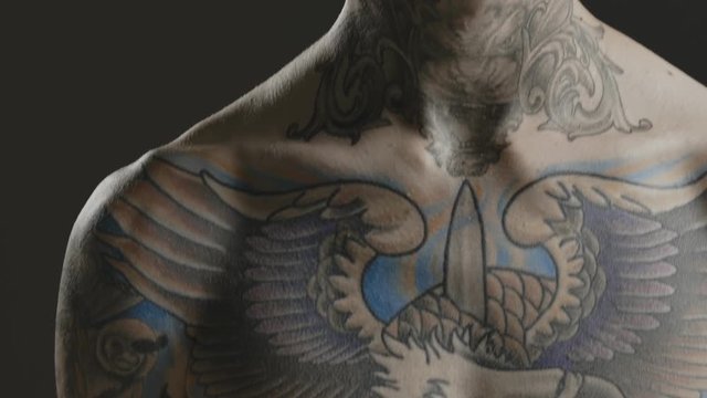Handsome sexy young man stylish with tattoo on his neck, torso and hand - ultra close up body and face detail - greenscreen Prores - cinematic lighting