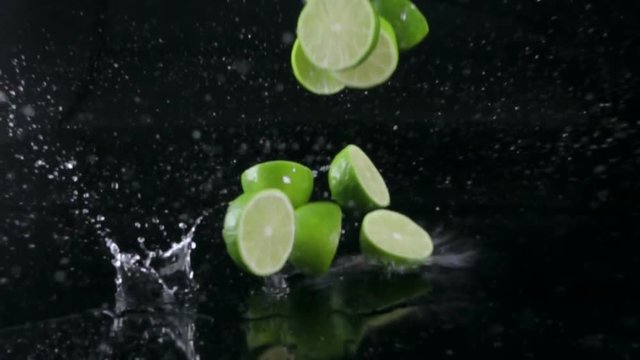 lime splashing on black background, slow motion